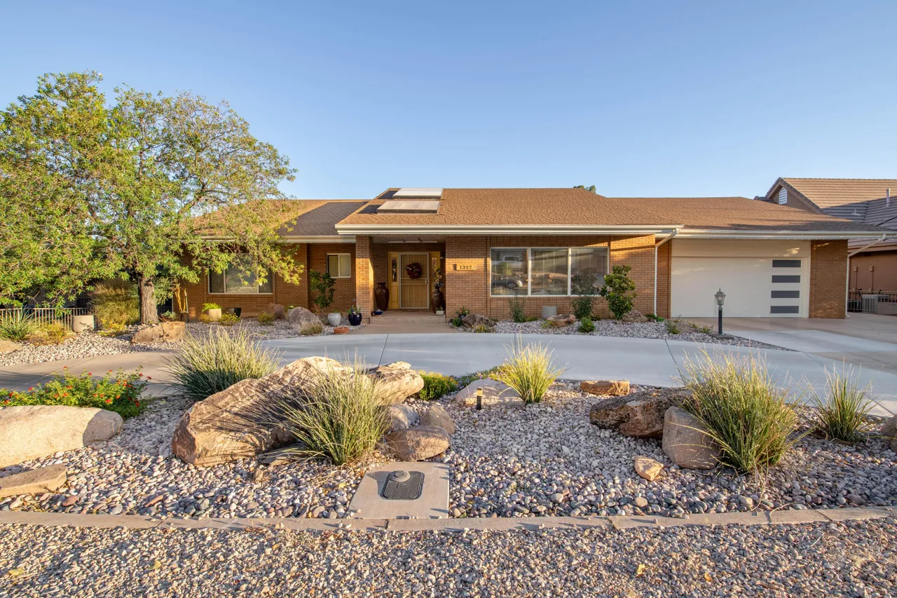 Modern resort villa with patio and desert landscaping in Washington County, Utah
